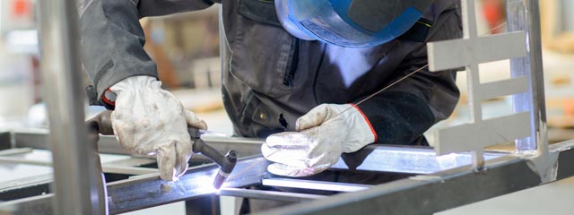 Man leaning over welding